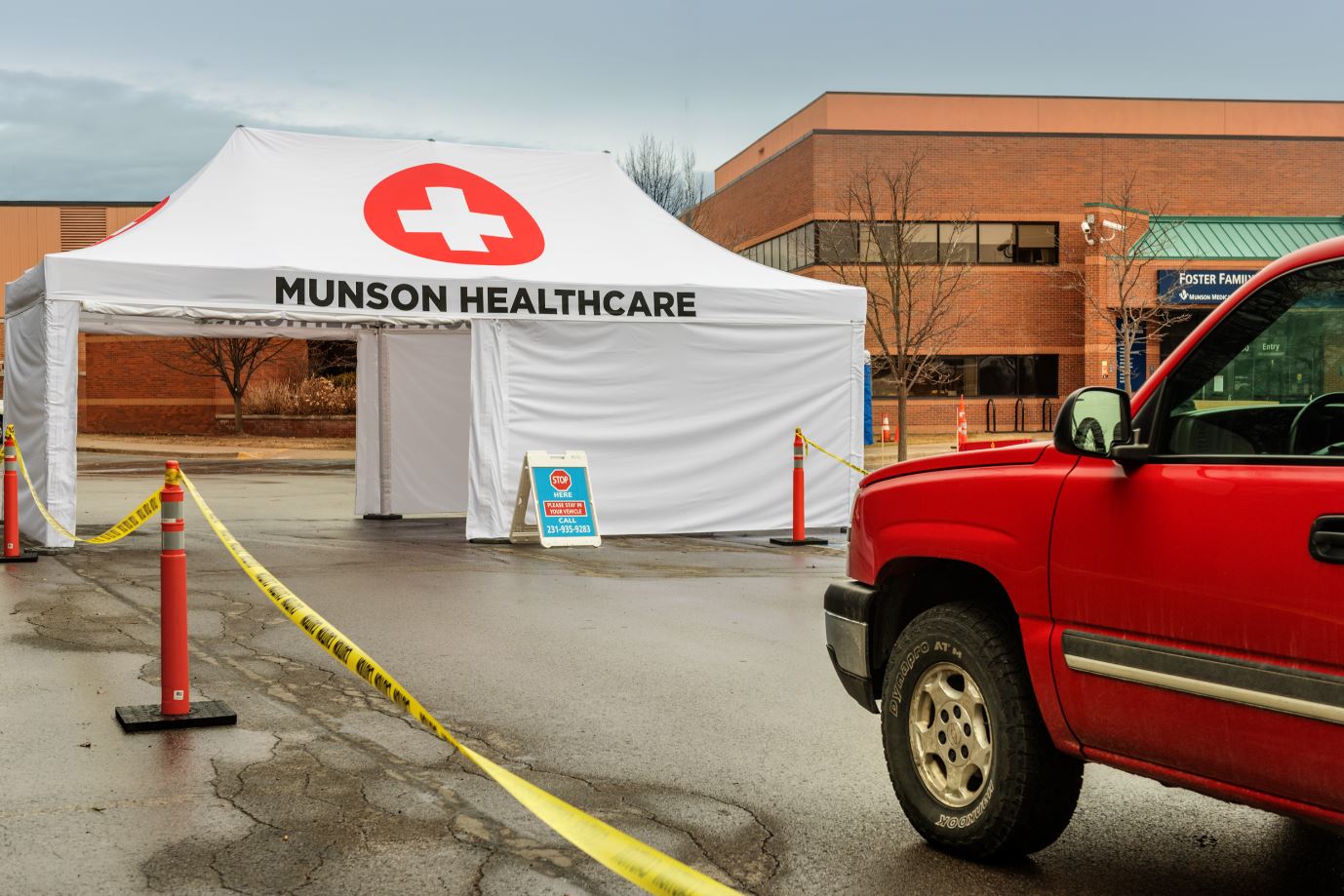 Munson healthcare drive through tent in parking lot in front of building