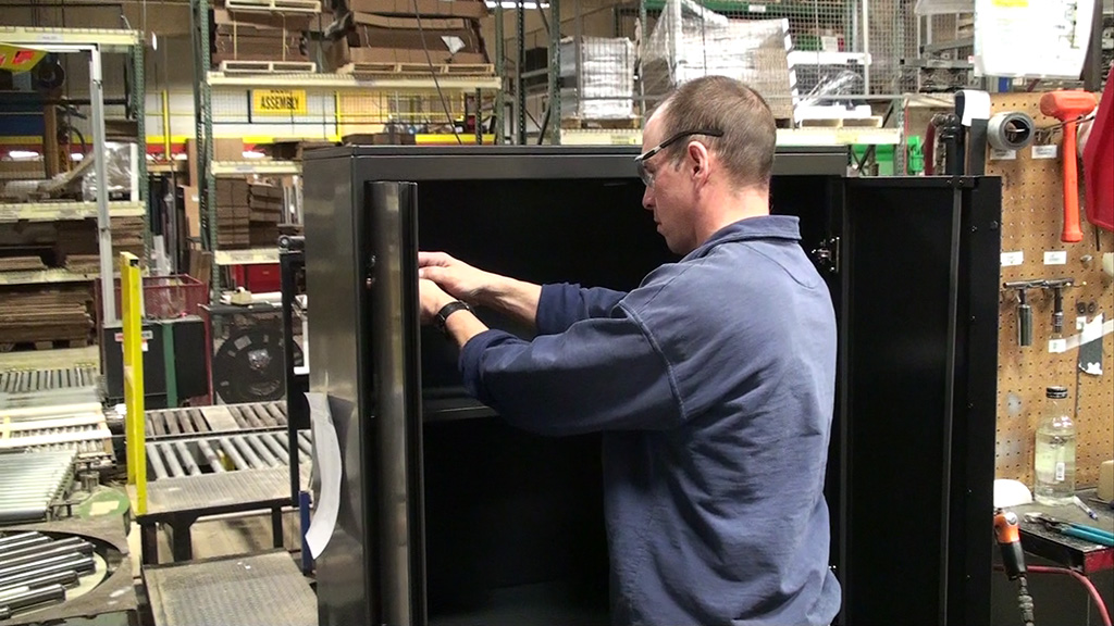 Employee working on inside of storage cabinet