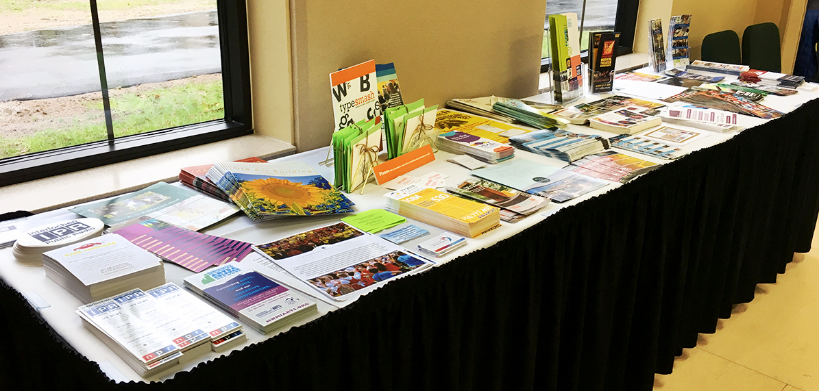 Table with stacks of various brochures